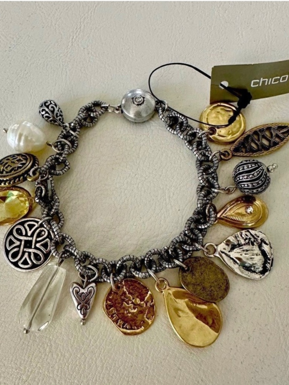 Chico’s vintage style charm bracelet on silver chain.